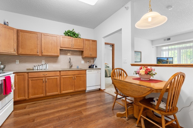 1880 3rd Ave NW Unit 202, Rochester, MN 55901 - kitchen featuring white appliances, a sink, a textured ceiling, light countertops, and wood finished floors
