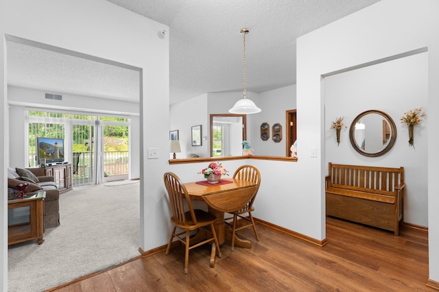 1880 3rd Ave NW Unit 202, Rochester, MN 55901 - dining area with wood finished floors, baseboards, and a textured ceiling