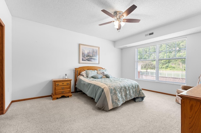 1880 3rd Ave NW Unit 202, Rochester, MN 55901 - bedroom with light colored carpet, baseboards, a textured ceiling, and ceiling fan