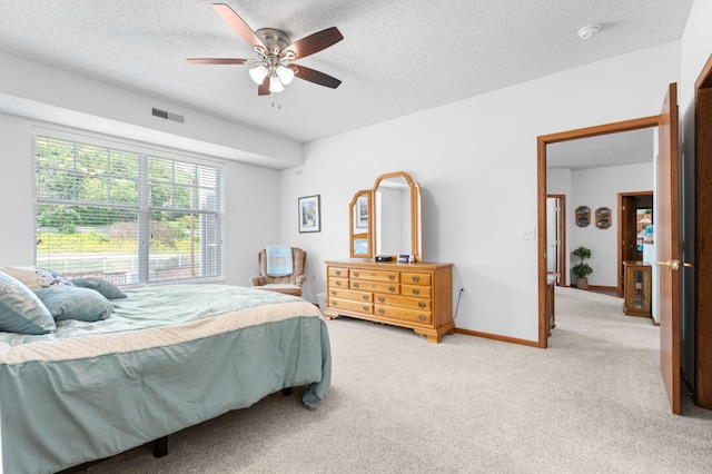 1880 3rd Ave NW Unit 202, Rochester, MN 55901 - bedroom with light colored carpet, a textured ceiling, ceiling fan, and baseboards