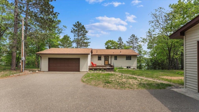 13956 Hardy Lake Rd SW, Pillager, MN 56473 - view of front of house with an attached garage, asphalt driveway, and a front lawn