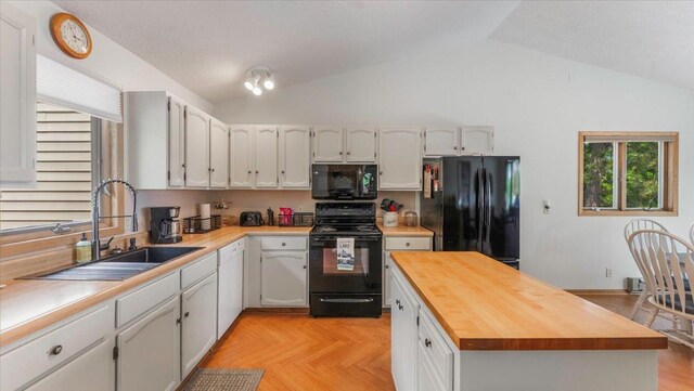 13956 Hardy Lake Rd SW, Pillager, MN 56473 - kitchen with black appliances, a sink, butcher block countertops, lofted ceiling, and a kitchen island
