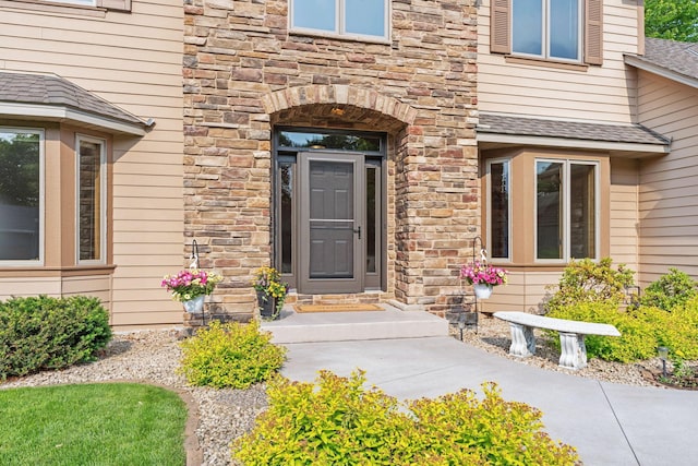 6617 Orchid Ln N, Maple Grove, MN 55311 - doorway to property with stone siding and a shingled roof
