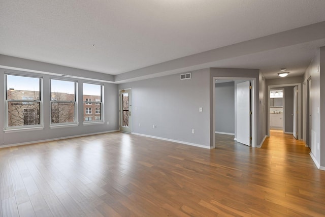 560 2nd St Unit 302, Minneapolis, MN 55401 - spare room with baseboards and wood finished floors