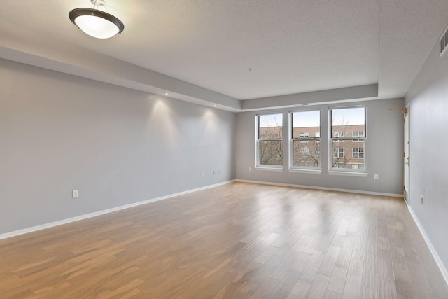 560 2nd St Unit 302, Minneapolis, MN 55401 - unfurnished room featuring wood finished floors, baseboards, and a textured ceiling