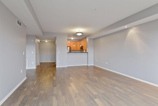 560 2nd St Unit 302, Minneapolis, MN 55401 - unfurnished living room featuring dark wood-style floors and baseboards