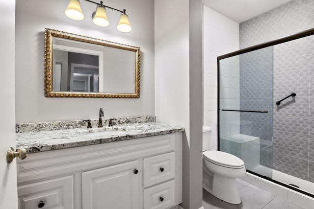 560 2nd St Unit 302, Minneapolis, MN 55401 - bathroom featuring vanity, a stall shower, toilet, and tile patterned floors