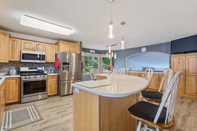 4910 Upper 148th Ct, Apple Valley, MN 55124 - kitchen with stainless steel appliances, light countertops, and light wood finished floors