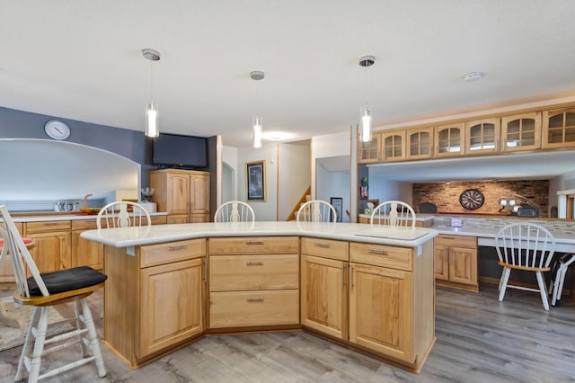 4910 Upper 148th Ct, Apple Valley, MN 55124 - kitchen featuring light countertops, light wood-type flooring, tasteful backsplash, and glass insert cabinets