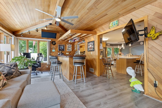 4910 Upper 148th Ct, Apple Valley, MN 55124 - indoor wet bar featuring wood walls, rail lighting, wood finished floors, wooden ceiling, and lofted ceiling
