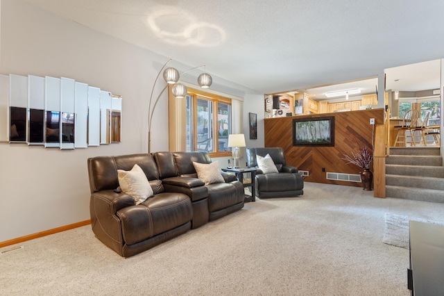 4910 Upper 148th Ct, Apple Valley, MN 55124 - living area with carpet, wooden walls, and stairs