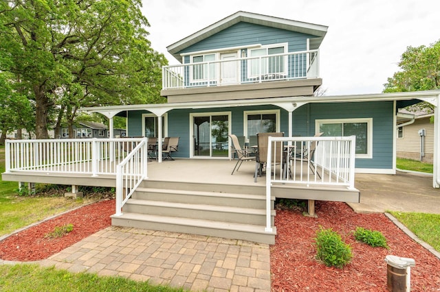 27326 Cloverleaf Ln, Everts Twp, MN 56515 - view of front facade featuring a balcony and outdoor dining area