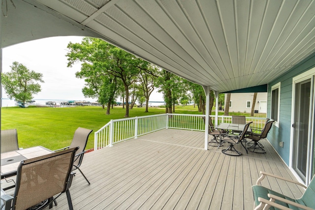 27326 Cloverleaf Ln, Everts Twp, MN 56515 - wooden terrace with outdoor dining area and a lawn