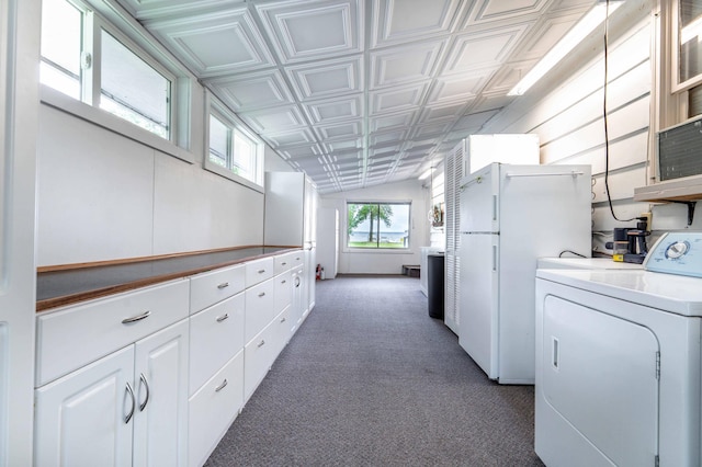 27326 Cloverleaf Ln, Everts Twp, MN 56515 - kitchen featuring washer / clothes dryer, freestanding refrigerator, an ornate ceiling, white cabinetry, and carpet floors