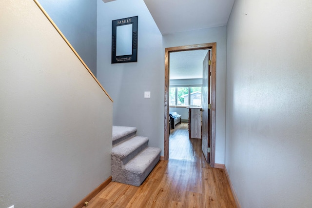 27326 Cloverleaf Ln, Everts Twp, MN 56515 - hallway featuring light wood finished floors, baseboards, and stairs