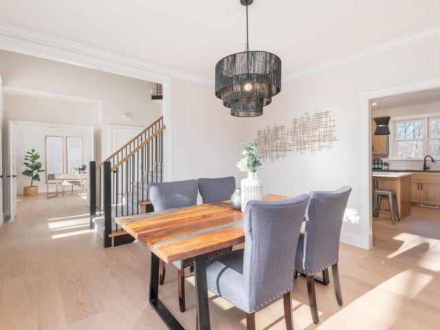 7010 Oak Ridge Rd, Corcoran, MN 55340 - dining room featuring light wood finished floors, stairs, ornamental molding, and a chandelier