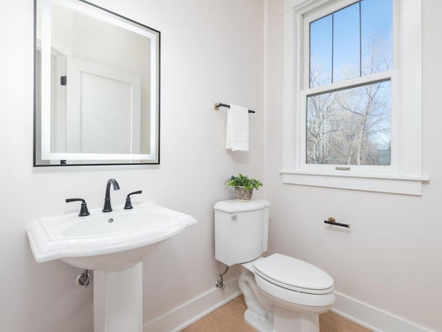 7010 Oak Ridge Rd, Corcoran, MN 55340 - bathroom with baseboards, toilet, and wood finished floors