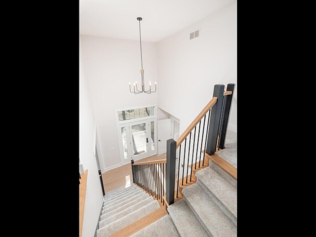 7010 Oak Ridge Rd, Corcoran, MN 55340 - stairway featuring a chandelier and baseboards