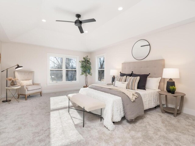 7010 Oak Ridge Rd, Corcoran, MN 55340 - carpeted bedroom with a raised ceiling, multiple windows, recessed lighting, baseboards, and ceiling fan