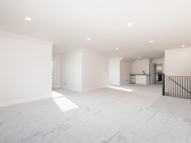 7010 Oak Ridge Rd, Corcoran, MN 55340 - unfurnished living room featuring light colored carpet, a sink, recessed lighting, and baseboards