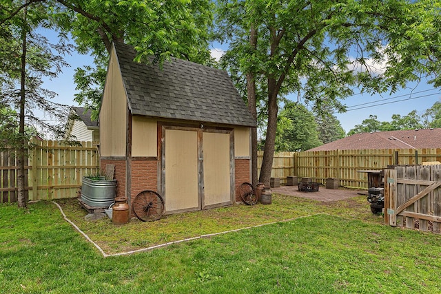 310 Belle St W, Cannon Falls, MN 55009 - view of shed with a fenced backyard and an outdoor fire pit