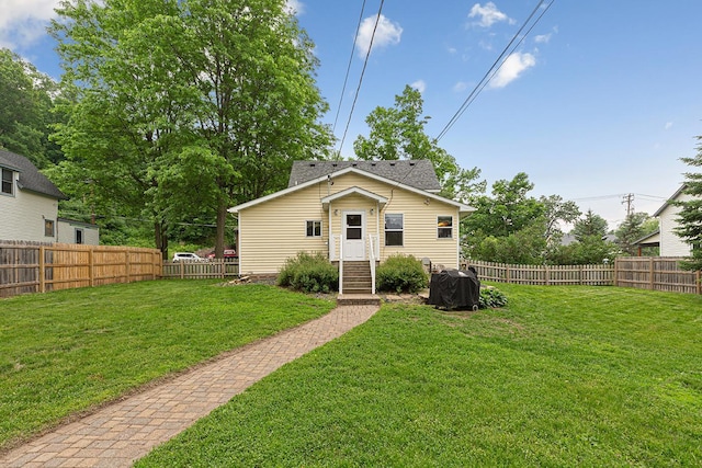 310 Belle St W, Cannon Falls, MN 55009 - rear view of house with entry steps and a fenced backyard