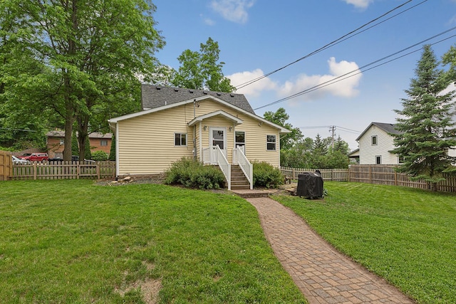 310 Belle St W, Cannon Falls, MN 55009 - view of front facade with a fenced backyard and a shingled roof