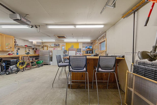 310 Belle St W, Cannon Falls, MN 55009 - garage with a workshop area and a garage door opener