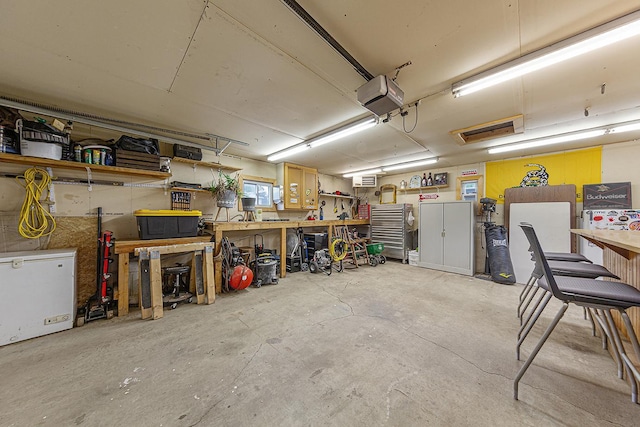 310 Belle St W, Cannon Falls, MN 55009 - garage with a workshop area and a garage door opener