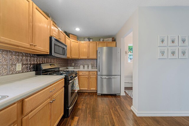310 Belle St W, Cannon Falls, MN 55009 - kitchen with appliances with stainless steel finishes, light countertops, dark wood-style floors, backsplash, and recessed lighting