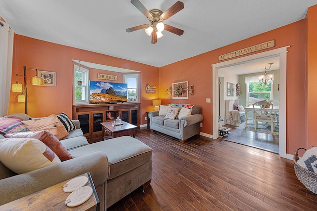 310 Belle St W, Cannon Falls, MN 55009 - living room featuring a chandelier, dark wood-style flooring, and a ceiling fan