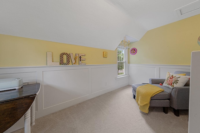 310 Belle St W, Cannon Falls, MN 55009 - living area with carpet flooring, vaulted ceiling, wainscoting, and a decorative wall