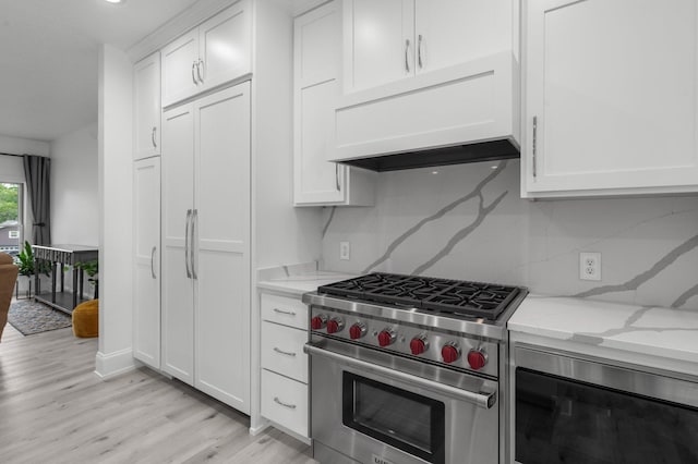 7447 213th St N, Forest Lake, MN 55025 - kitchen featuring premium stove, premium range hood, light wood-style flooring, light stone countertops, and white cabinets