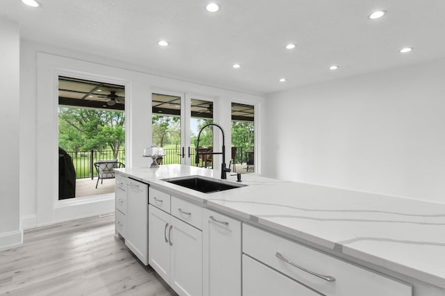 7447 213th St N, Forest Lake, MN 55025 - kitchen with a sink, recessed lighting, white dishwasher, light wood-style floors, and white cabinetry