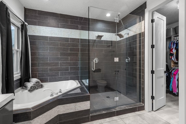 7447 213th St N, Forest Lake, MN 55025 - full bathroom with a stall shower, a garden tub, a walk in closet, tile patterned flooring, and toilet