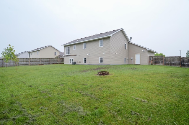 1046 Roosevelt St S, Cambridge, MN 55008 - back of house featuring a fire pit and a fenced backyard