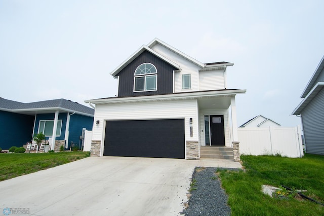 7364 27th St S, Fargo, ND 58104 - view of front of home featuring stone siding, a garage, and driveway