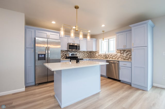 7364 27th St S, Fargo, ND 58104 - kitchen with appliances with stainless steel finishes, decorative backsplash, light wood finished floors, light countertops, and recessed lighting