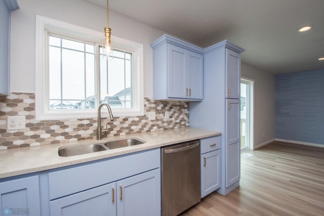 7364 27th St S, Fargo, ND 58104 - kitchen with stainless steel dishwasher, a sink, plenty of natural light, light wood finished floors, and recessed lighting