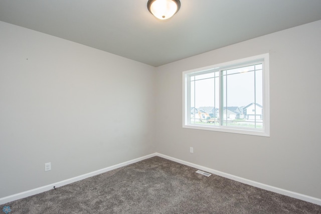 7364 27th St S, Fargo, ND 58104 - spare room with dark colored carpet and baseboards