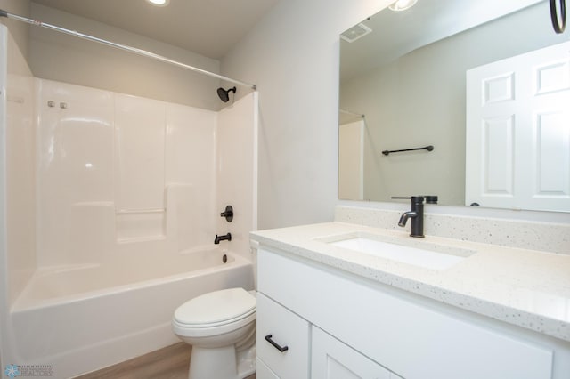 7364 27th St S, Fargo, ND 58104 - full bathroom featuring toilet, vanity, washtub / shower combination, recessed lighting, and wood finished floors