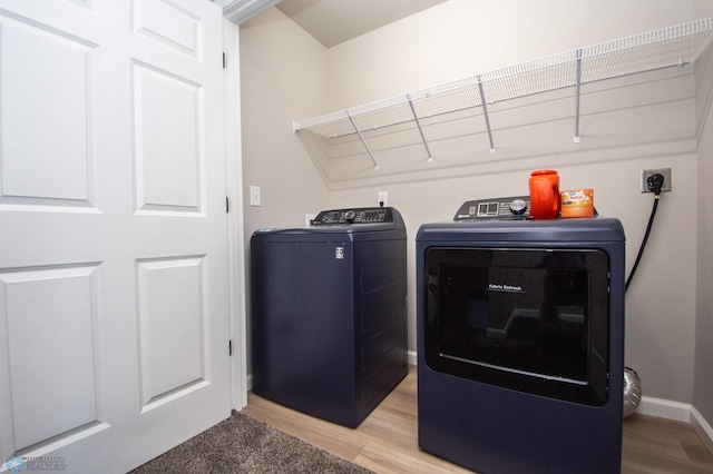 7364 27th St S, Fargo, ND 58104 - laundry room with washer and clothes dryer, light wood-style flooring, and baseboards