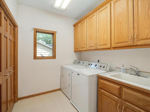 1875 26th Ave NW, New Brighton, MN 55112 - laundry area featuring washing machine and clothes dryer, cabinet space, light floors, and baseboards