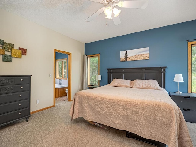 1875 26th Ave NW, New Brighton, MN 55112 - bedroom with light colored carpet, a ceiling fan, ensuite bathroom, and baseboards