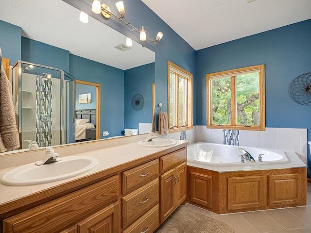 1875 26th Ave NW, New Brighton, MN 55112 - full bath with tile patterned floors, a shower stall, double vanity, a garden tub, and ensuite bathroom