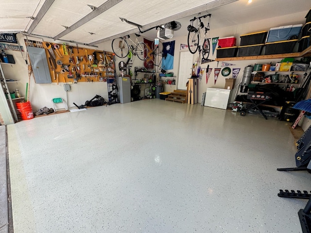 1875 26th Ave NW, New Brighton, MN 55112 - garage featuring electric panel and a workshop area
