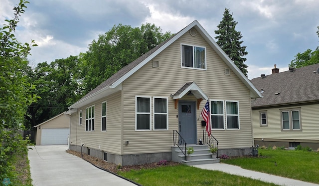 1442 11th Ave S, Fargo, ND 58103 - bungalow-style house featuring entry steps, an outdoor structure, a garage, and a front lawn