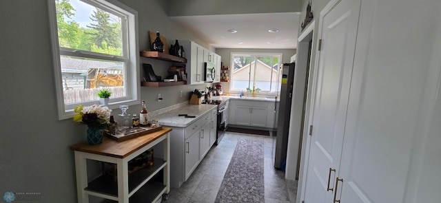 1442 11th Ave S, Fargo, ND 58103 - kitchen featuring open shelves, appliances with stainless steel finishes, a sink, butcher block counters, and recessed lighting