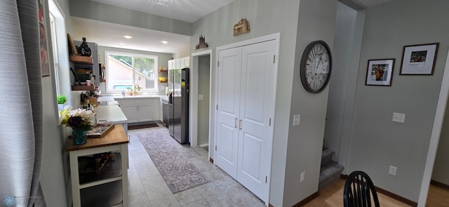 1442 11th Ave S, Fargo, ND 58103 - hall featuring stairway, a sink, and baseboards