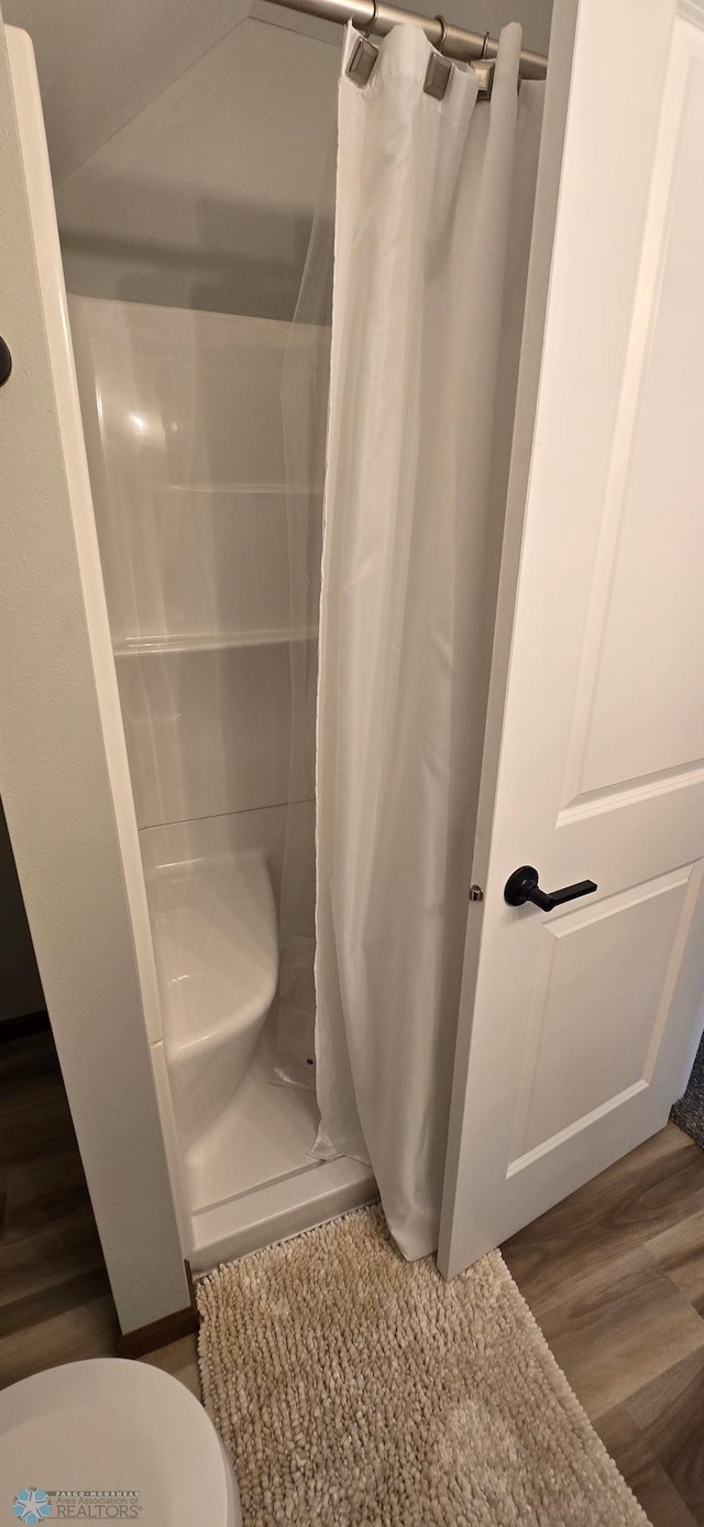 1442 11th Ave S, Fargo, ND 58103 - bathroom featuring a stall shower, toilet, and wood finished floors